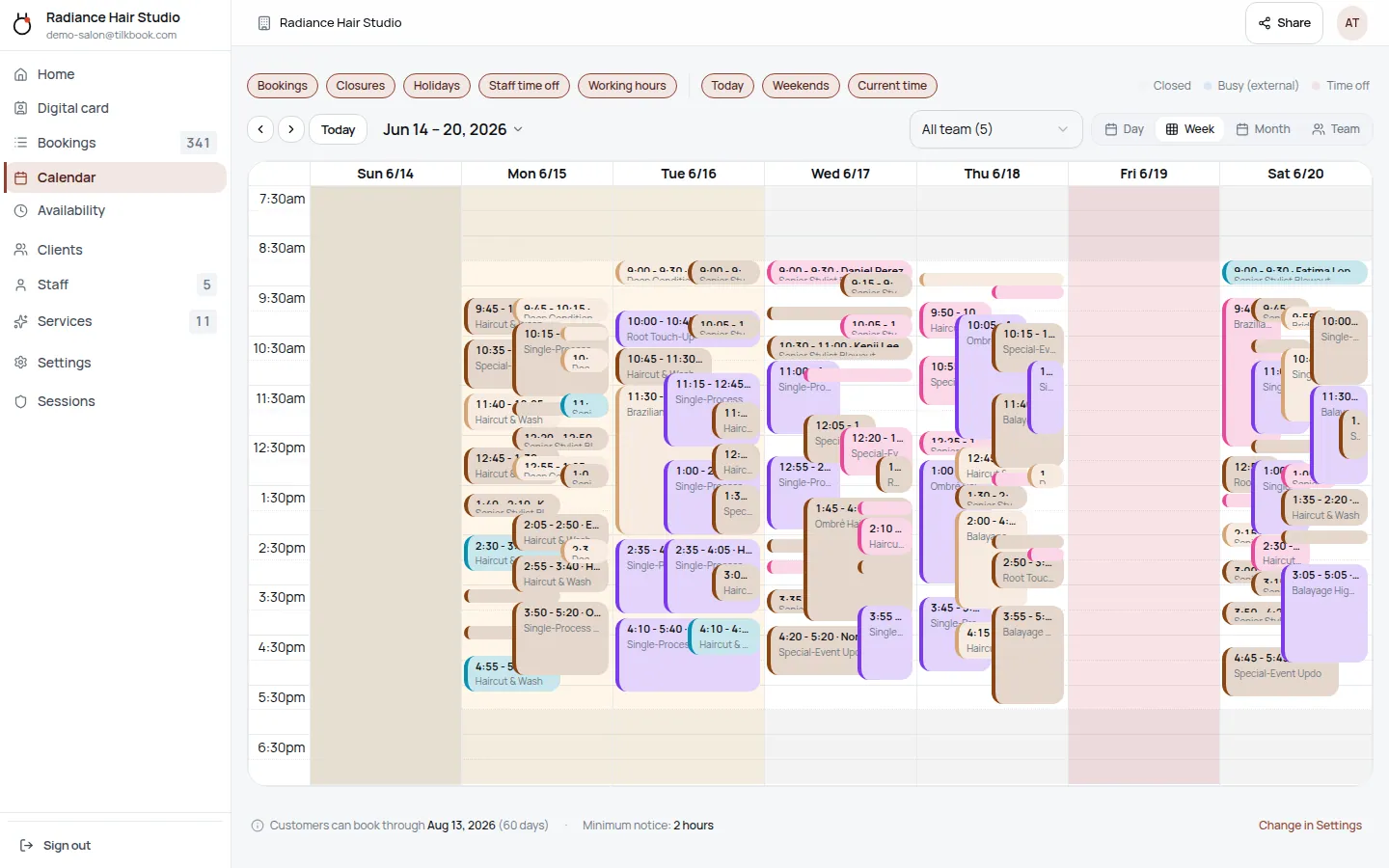A tilkbook week calendar — colour-coded appointments stacked across every staff member, Sunday to Saturday